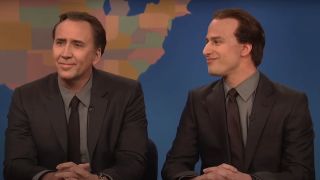 A smiling Nicolas Cage next to Andy Samberg as Nicolas Cage on SNL