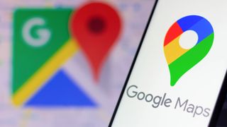Google Maps logo on smartphone with Google Maps logo in background