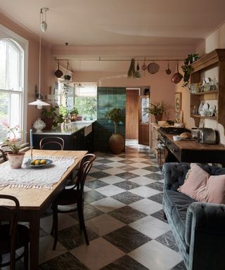 devol founder's kitchen with black and white marble floor tiles and a velvet couch