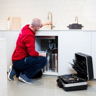 man installing boiling water tap