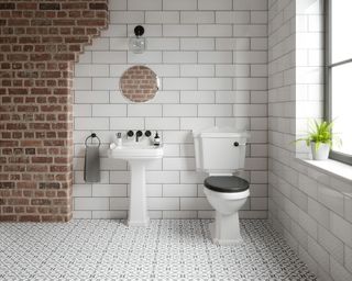 White bathroom decor with exposed brick wall by Tile Mountain