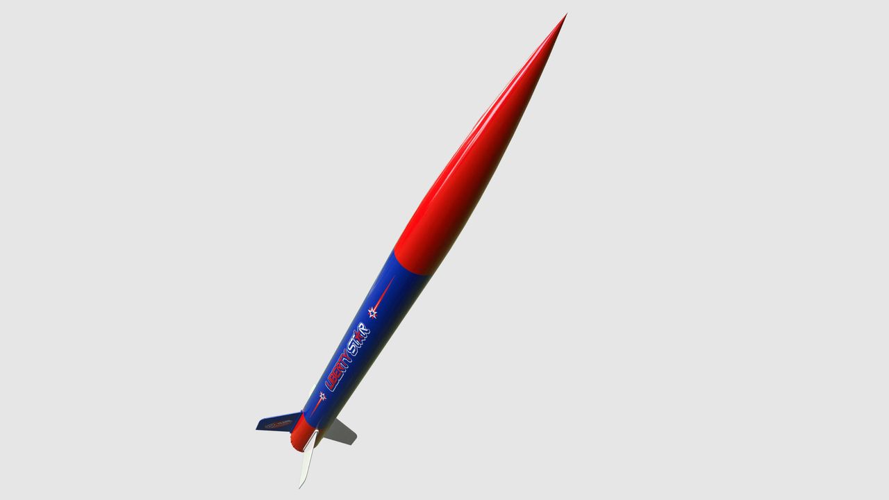 The Estes Liberty Star nose cone pointing upwards on a grey background.