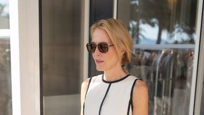 Gillian Anderson wearing a cream and black dress and black sunglasses