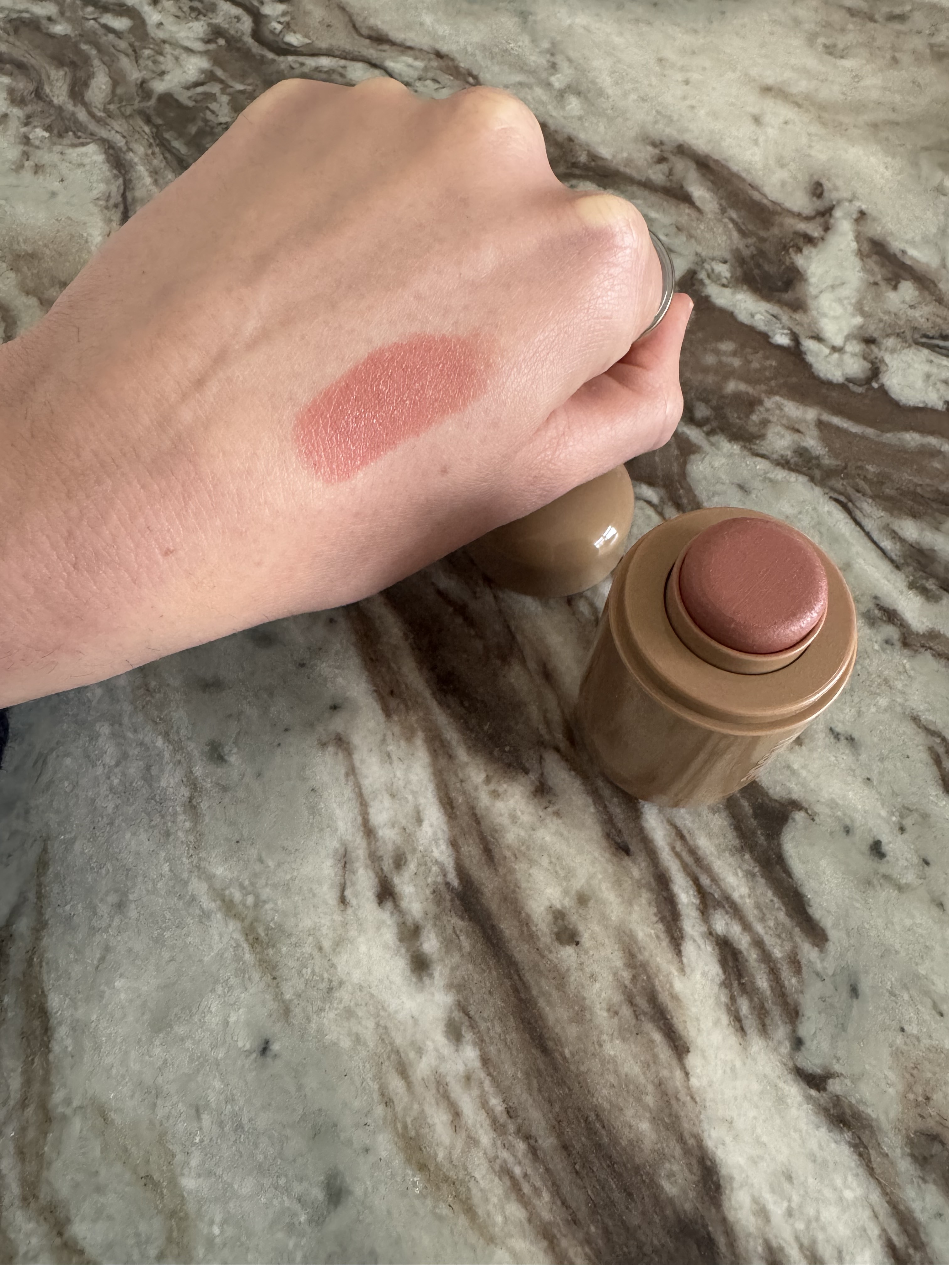 Rhode Pocket Blush in Tan Line swatched on the back of Eleanor's hand