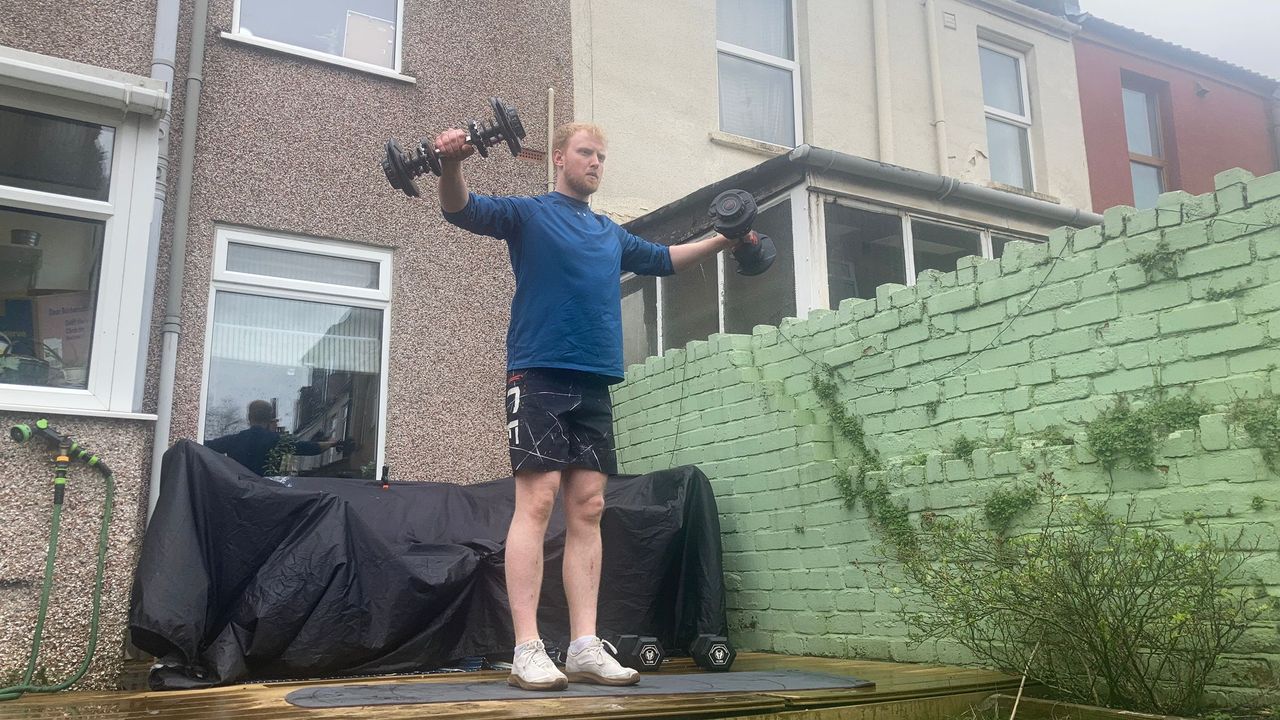 Fit&amp;Well fitness writer Harry Bullmore demonstrating a hammer curl to lateral raise
