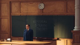 Professor T (Ben Miller) stands in his lecture hall in front of a blackboard, on which he has written "GENERAL STRAIN THEORY"