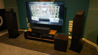 JBL entertainment system with a TV and speakers surrounding it