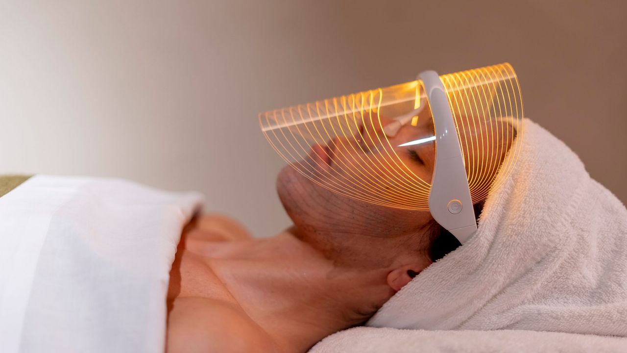 a woman wearing one of the best led face masks