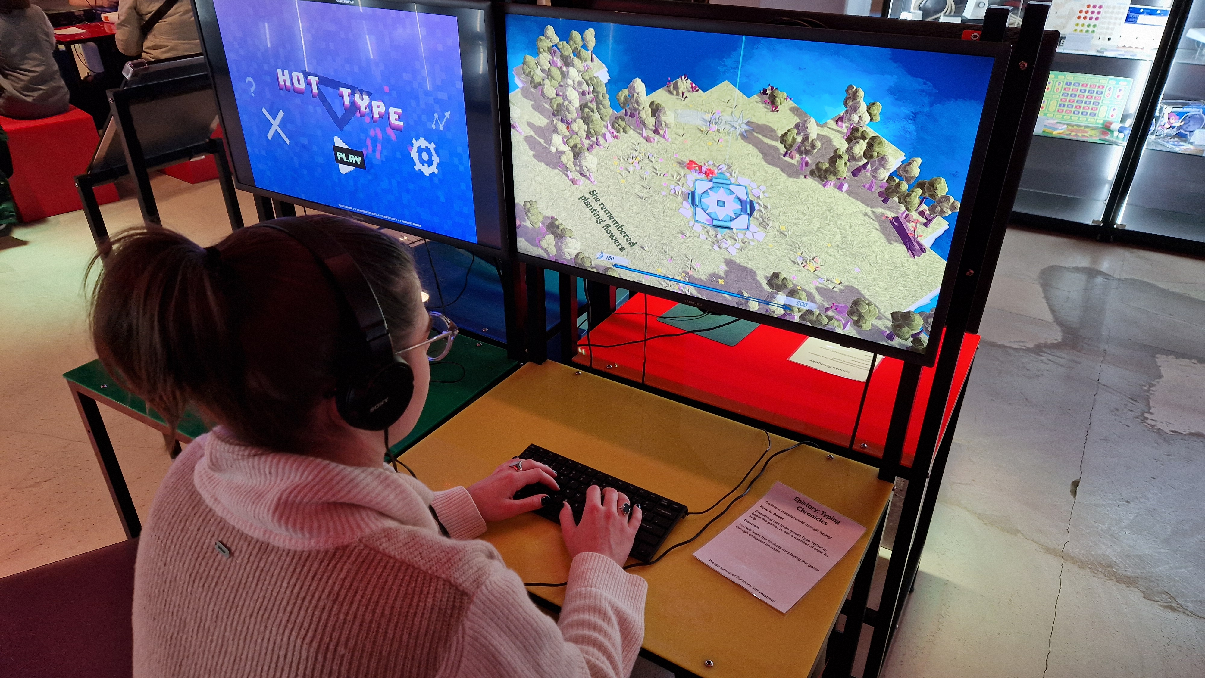 A woman playing a modern game at the NVM with her back to the camera