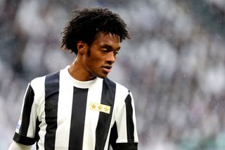 Juan Cuadrado in action for Juventus in a special kit to mark the club's 120th anniversary in a game against Benevento Calcio in November 2017.