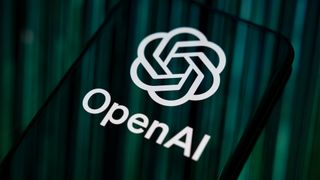 Close-up image of OpenAI logo and branding displayed on a smartphone screen. 