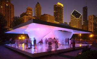 A modern-looking pavilion in white, with lights that cast different colors and people walking on it. We can see the city skyline in the back.
