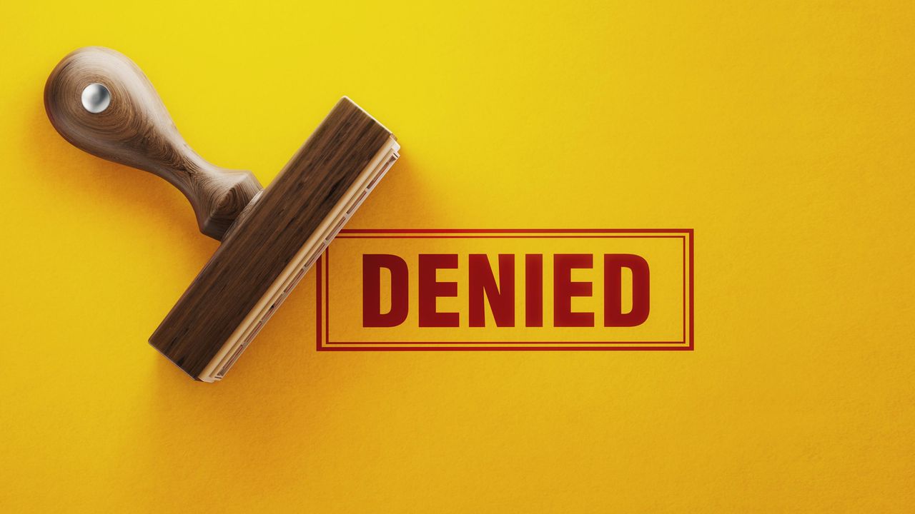 A rubber stamp prints the word &amp;quot;DENIED&amp;quot; in red.