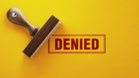 A rubber stamp prints the word "DENIED" in red.