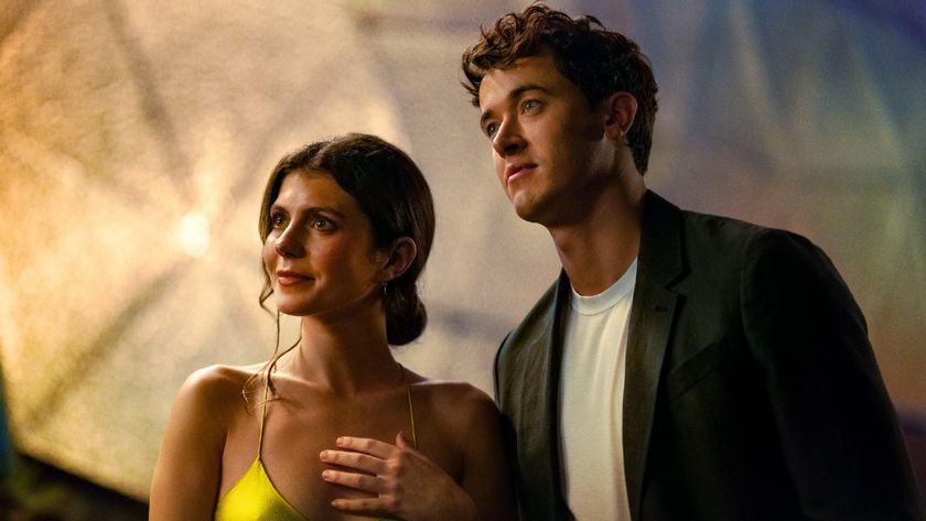 From left to right: Emily Bader standing next to Tom Blyth. They both look interested in whatever they&#039;re looking at. 