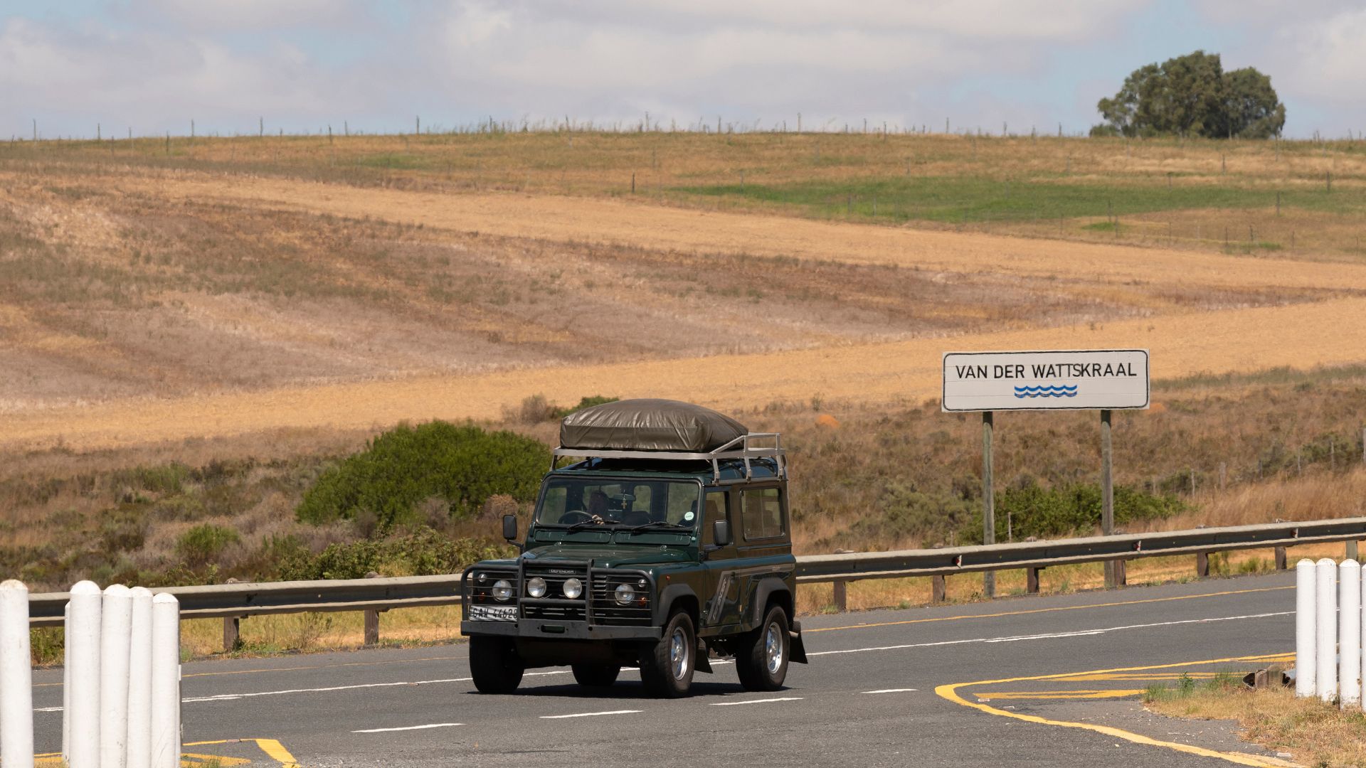 an image of a green land rover discovery travelling along an a-road