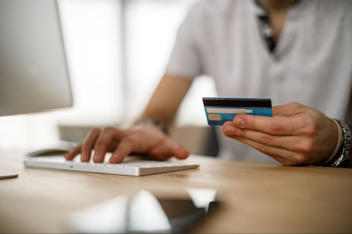 Man using credit card at computer