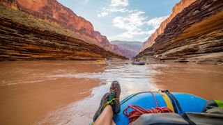Rafter floats down the Colorado River in the Grand Canyon