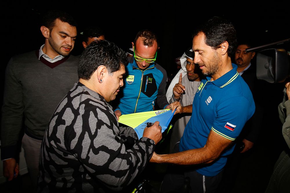 Tinkoff's Stefano Feltrin gets a jersey signed by football legend Diego Armando Maradona.