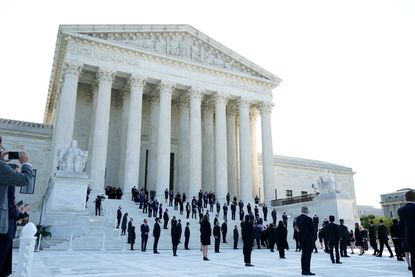 Ruth Bader Ginsburg's former law clerks line the Supreme Court steps.