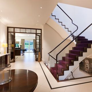 plain glass staircase and wooden table