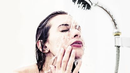 Woman in shower, washing face