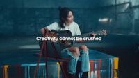 Screenshot of a girl playing guitar from a Samsung advert