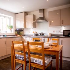 kitchen room with wooden cabinets and wooden table with chairs