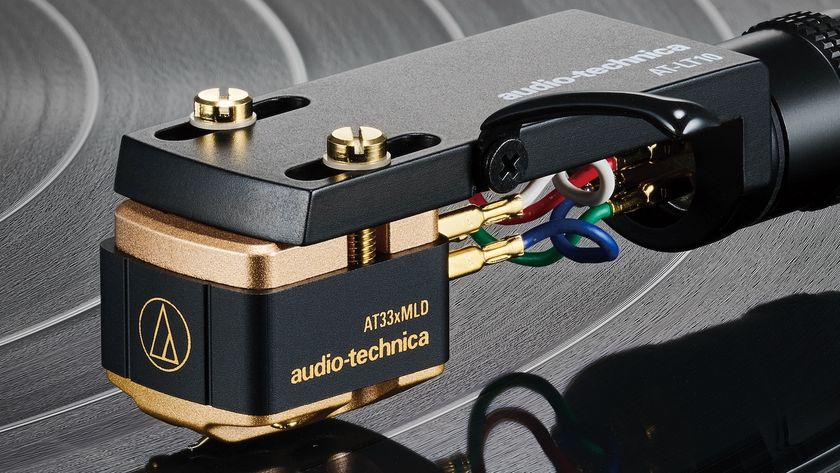 A close-up of an Audio-Technica AT33x Series cartridge holding a stylus on a vinyl record.