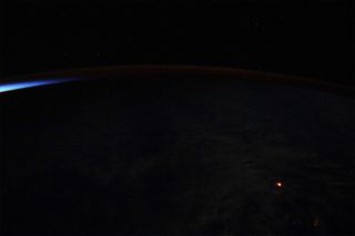 The lava glow from Hawaii's erupting Kilauea volcano shines an eerie orange in this nighttime photo taken by NASA astronaut Ricky Arnold on the International Space Station on June 20, 2018.