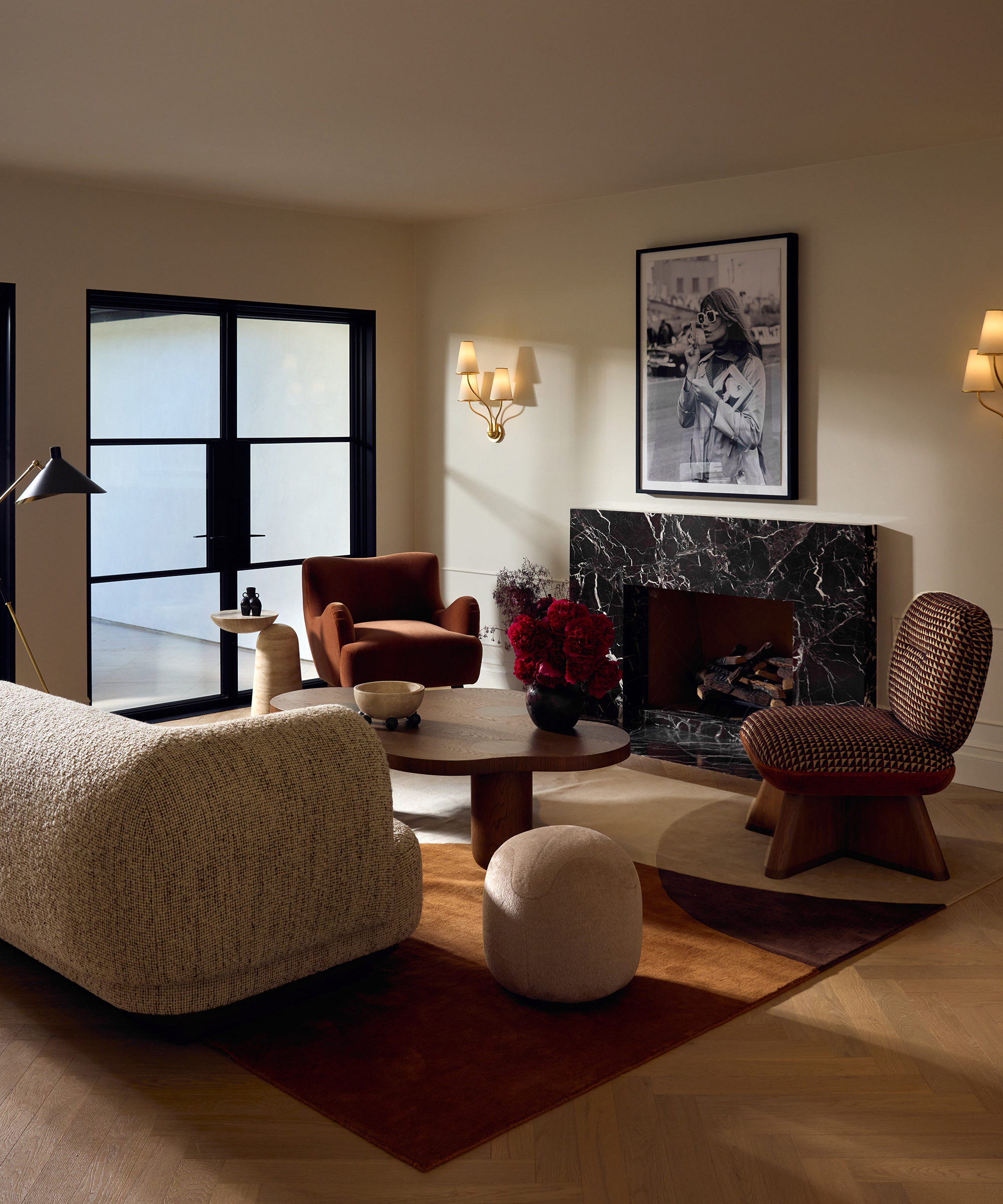 large white living room with modern furniture and black marble fireplace