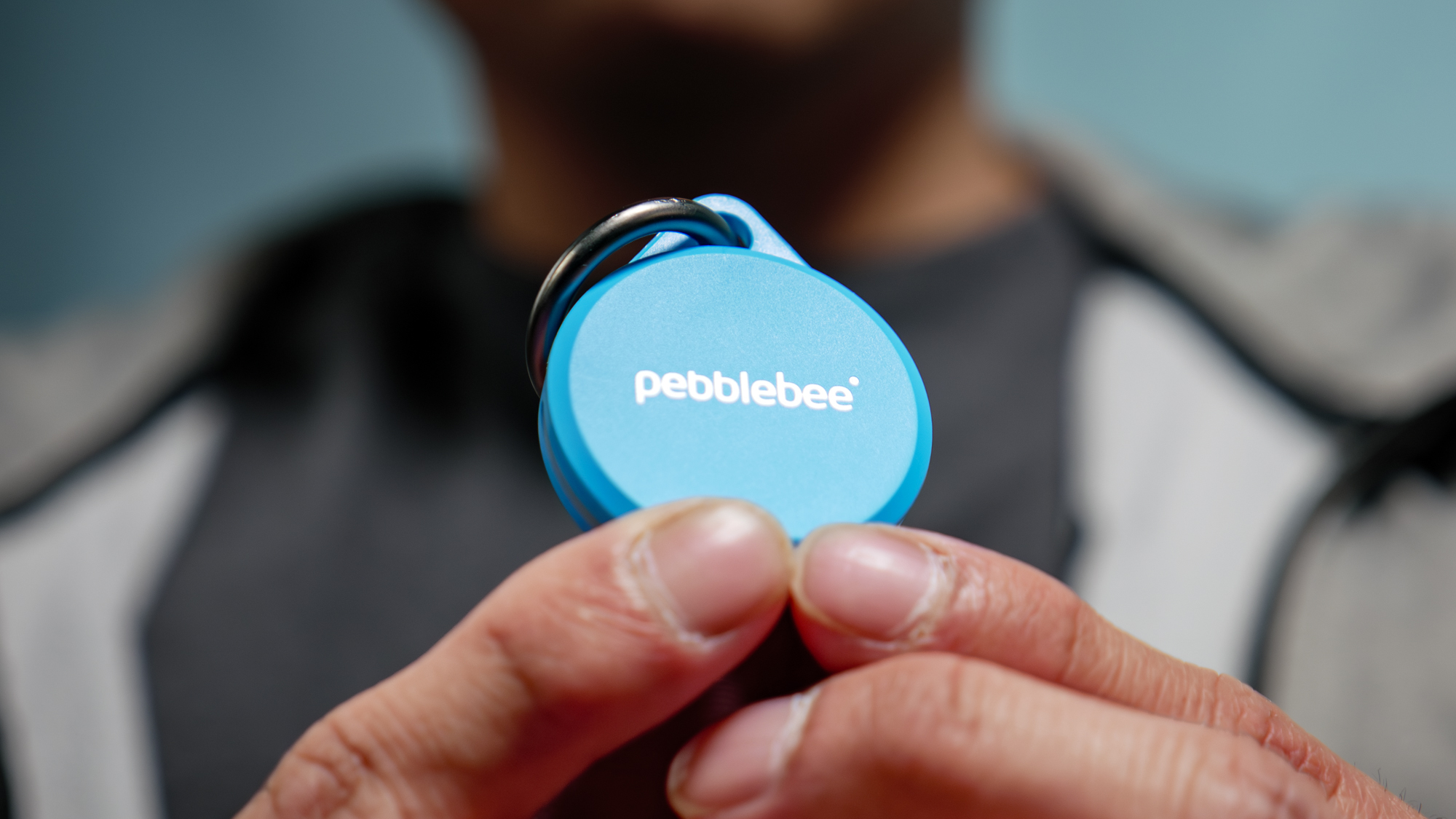 Pebblebee Clip 5 held in the hand.