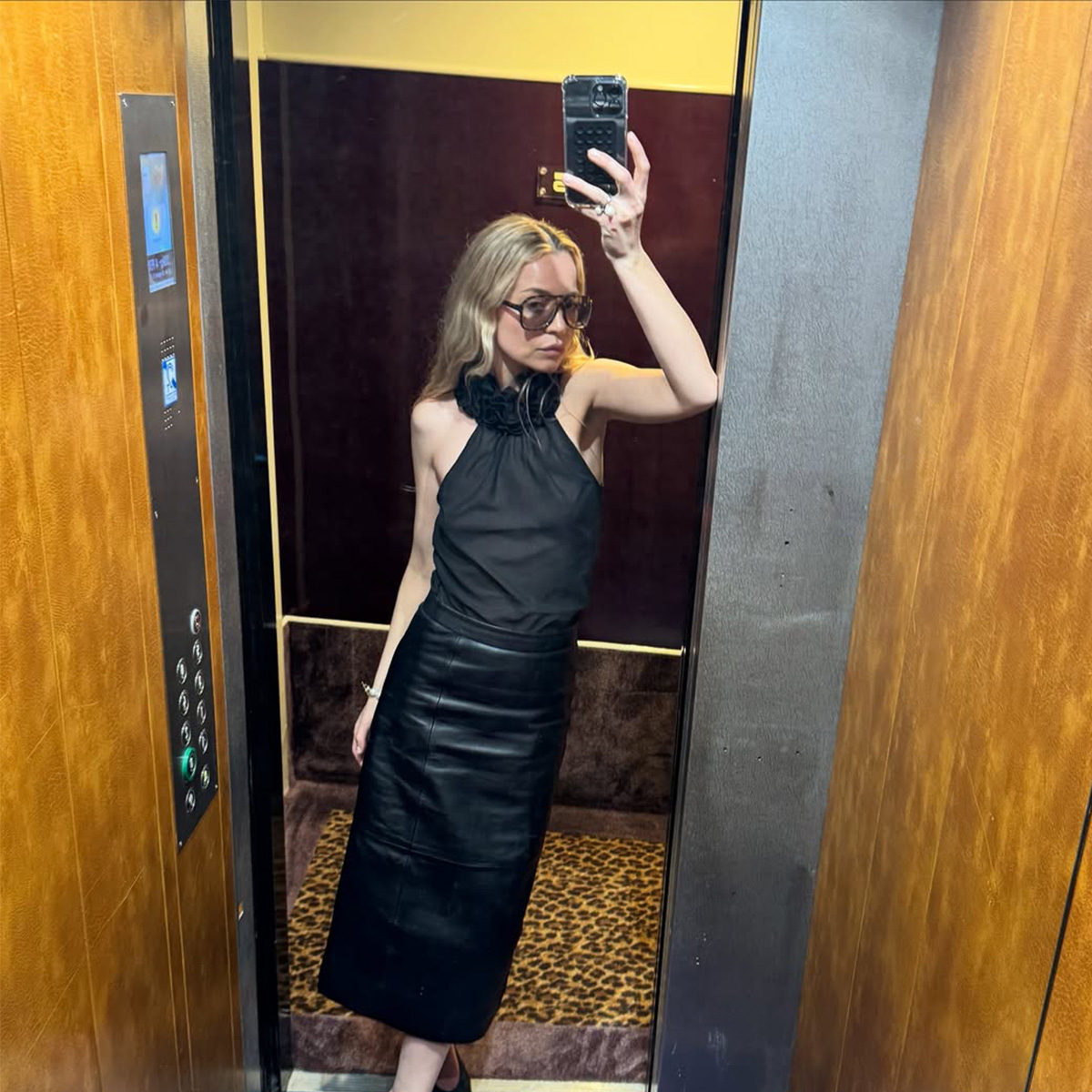 Stephanie Broek taking an elevator mirror selfie.