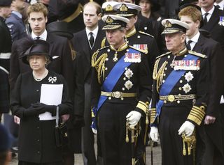 Queen Elizabeth II; Prince Charles, the Prince of Wales and Prince Philip, the Duke of Edinburgh stand in front of Prince William and Prince Harry at the Queen Mother's funeral