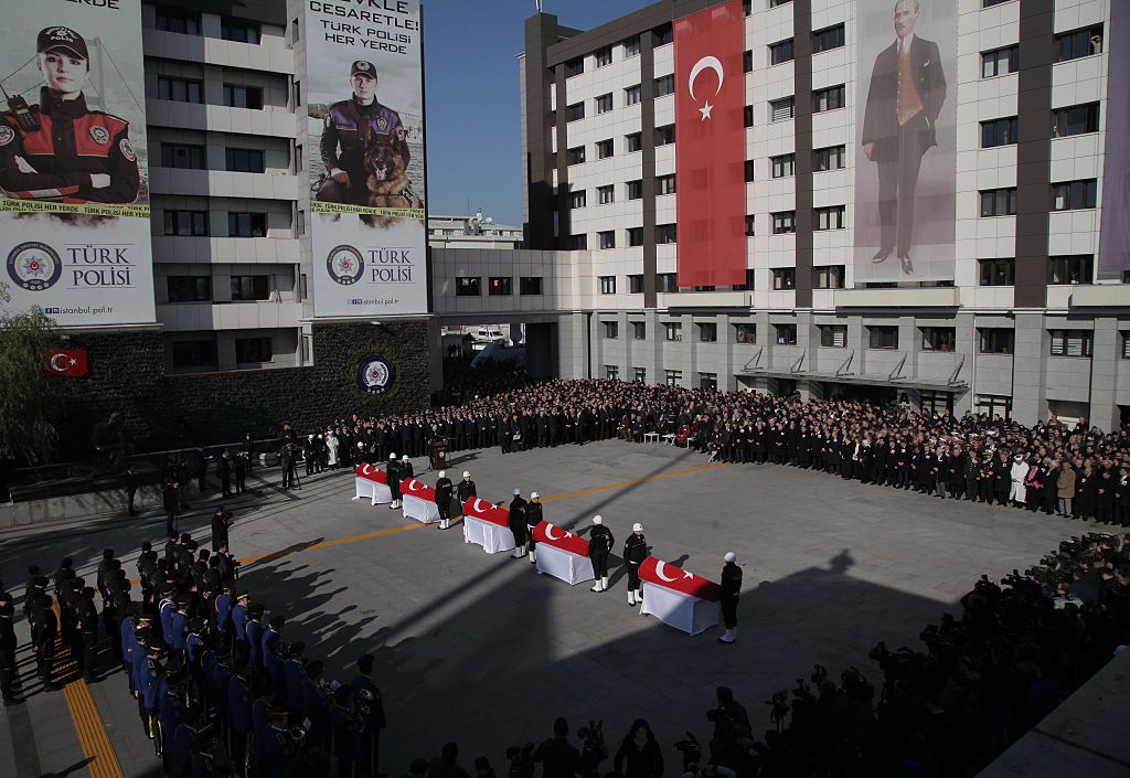 Turkish police officers stand guarded near the flag-draped coffins of police officers killed in yesterday&amp;#039;s blast on December 11, 2016 in Istanbul, Turkey