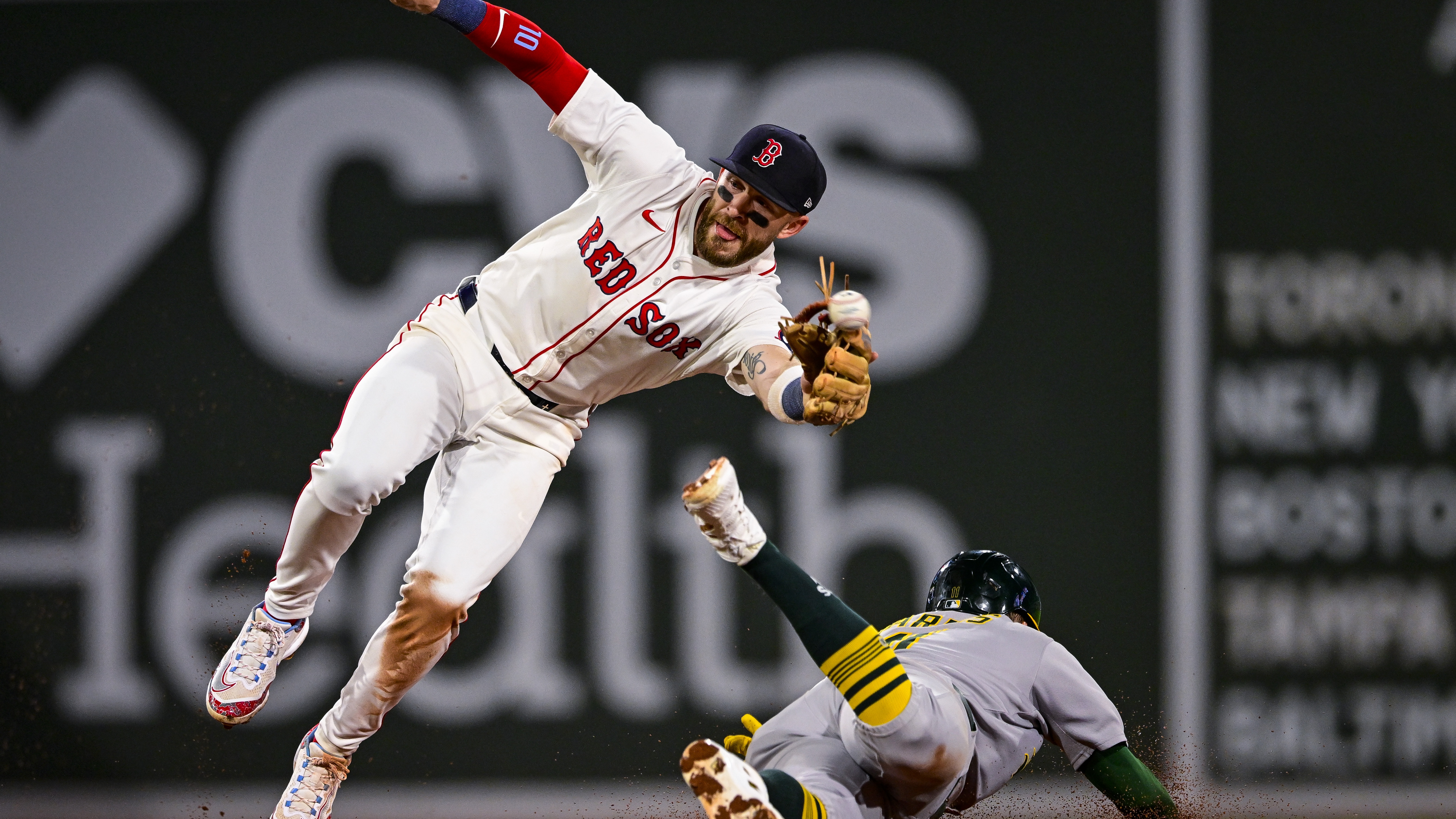 Brett Harris #11 of the Athletics safely steals second base against Trevor Story #10 of the Boston Red Sox in the fourth inning at Fenway Park on September 17, 2025 in Boston, Massachusetts. 