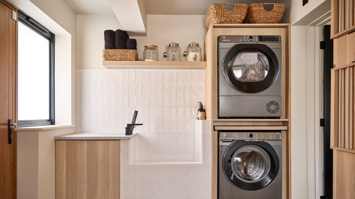 white and wooden modern utility room with black taps and dog sink