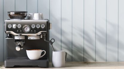 An example of how to get the most out of a coffee maker, an espresso machine in front of light blue, wooden pannels