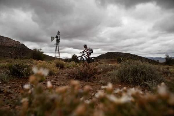 A rider negotiates a trail through a farm during the stage