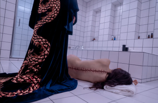 elisabeth sparkle's body after taking the substance activation in a still from the movie the substance