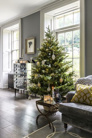 Christmas tree with georgian sash windows, mirrored furniture and wooden flooring