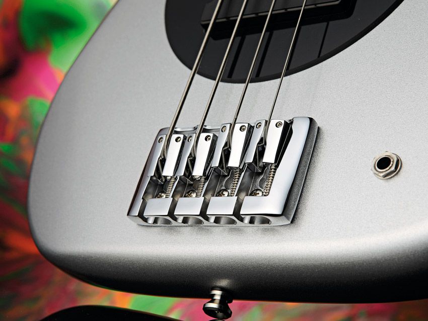 The bridge allows through-body or surface-anchored stringing.