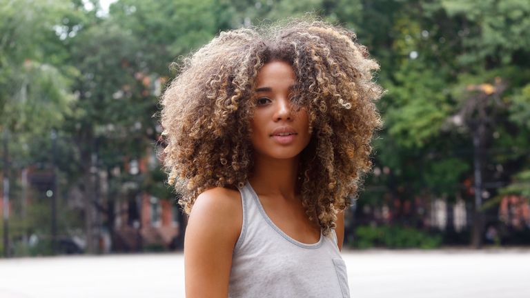 Girl with curly hair looking at the camera