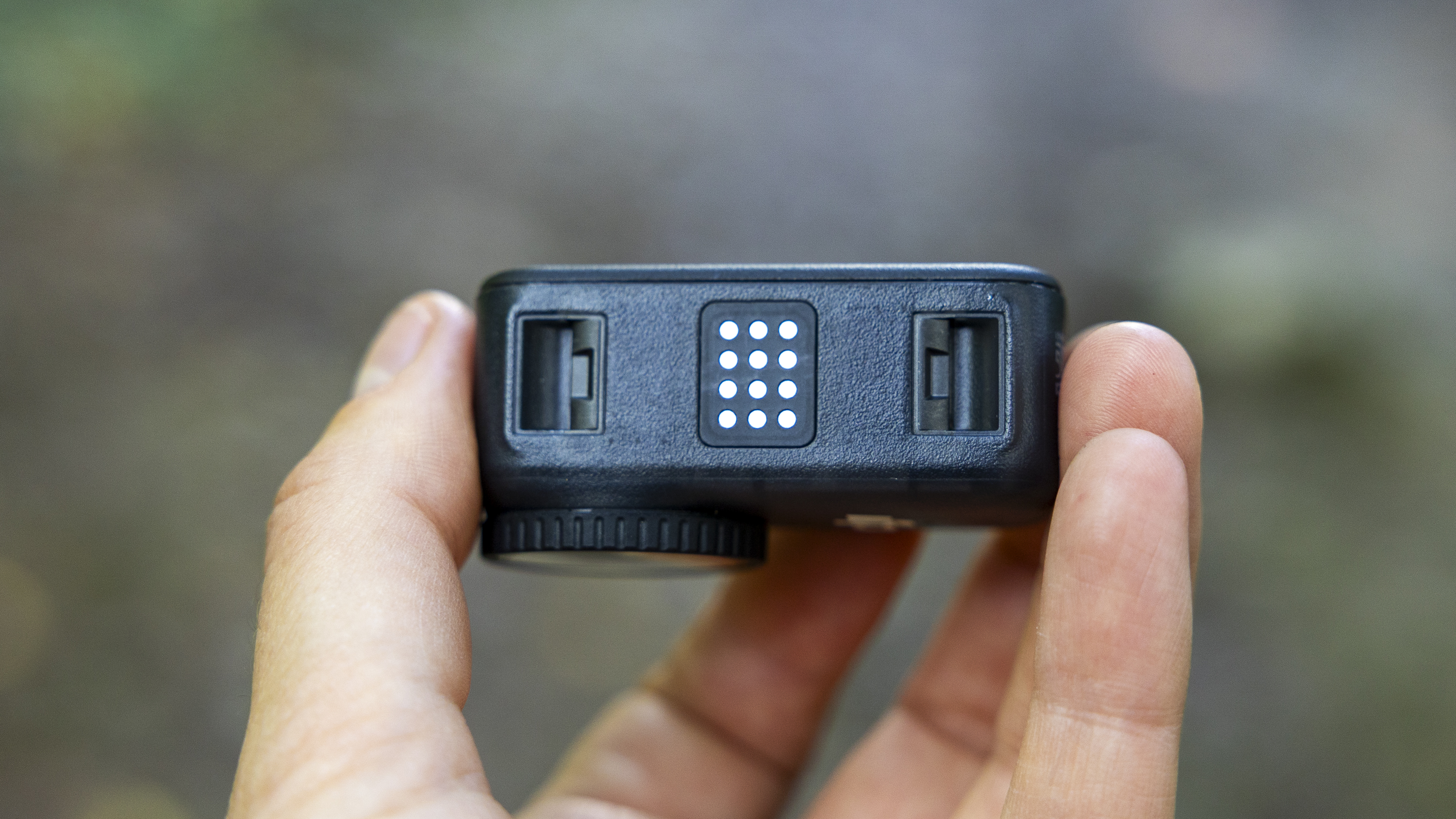 A female photographer holding the DJI Osmo Nano action camera