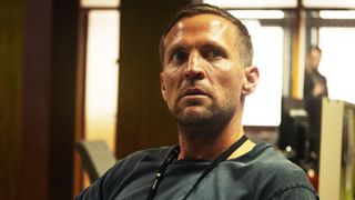 A police officer looks off to his left, concerned