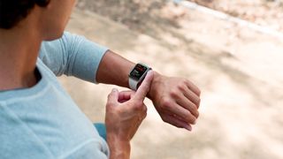 Apple Watch doing an ECG reading on a mans wrist.