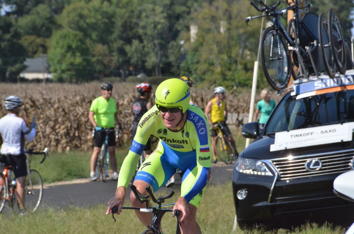 Michael Rogers grimaces as he starts pedalling again after the crash
