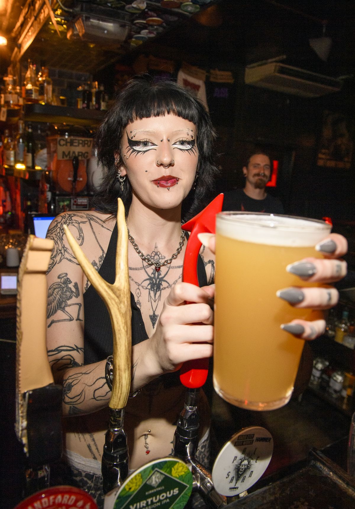 A bar worker pulling a pint