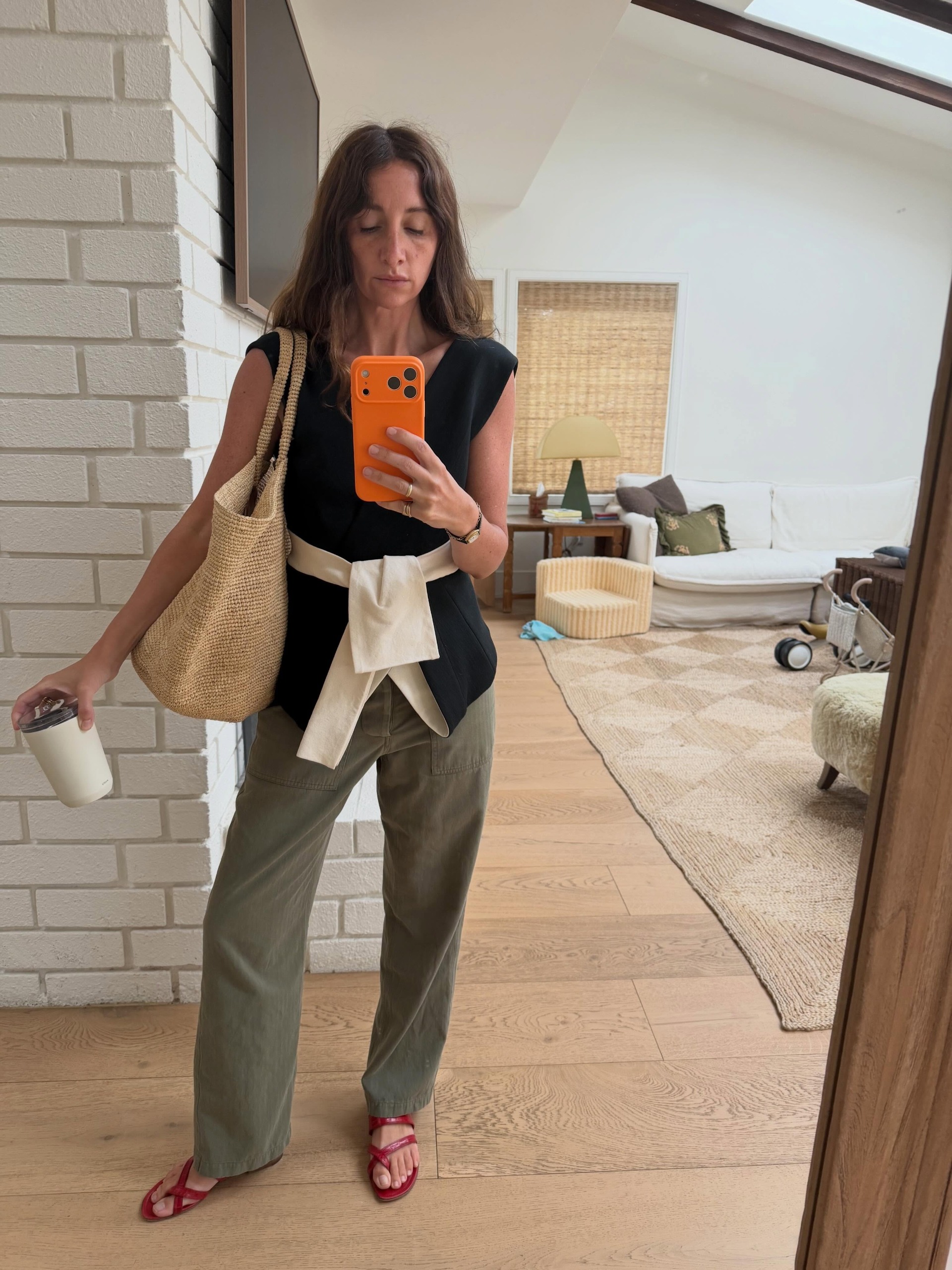 Woman in cargo pants and a top.