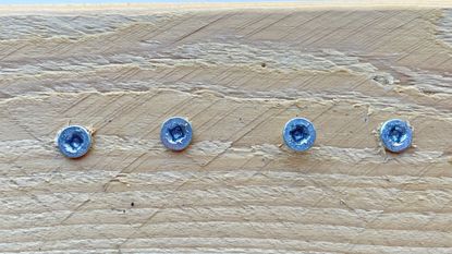 Stripped silver screws in a piece of wood
